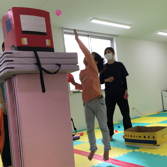 花咲くみらい カプリス四条段町(作業療法士の求人)の写真3枚目:ジャンプしてカラーボールを箱に入れよう!!遊びの中で身体の使い方を見ていきます。